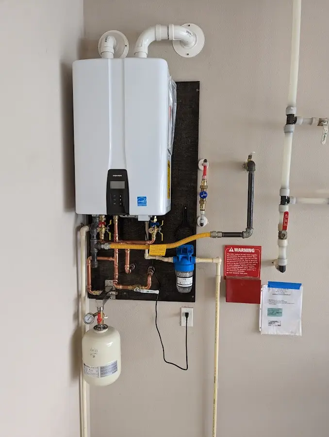 Professional plumber installing copper piping in a Sylvester home